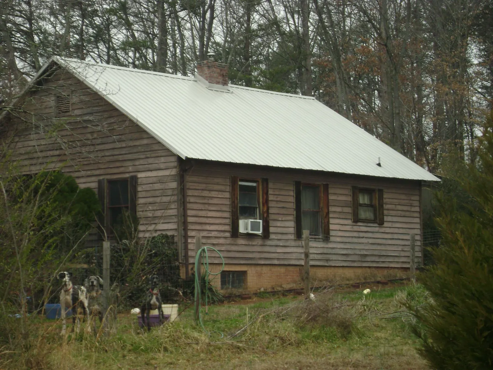White metal roof on an old wood sided farmhouse, from a Metal Roof Installation job in Reedsburg